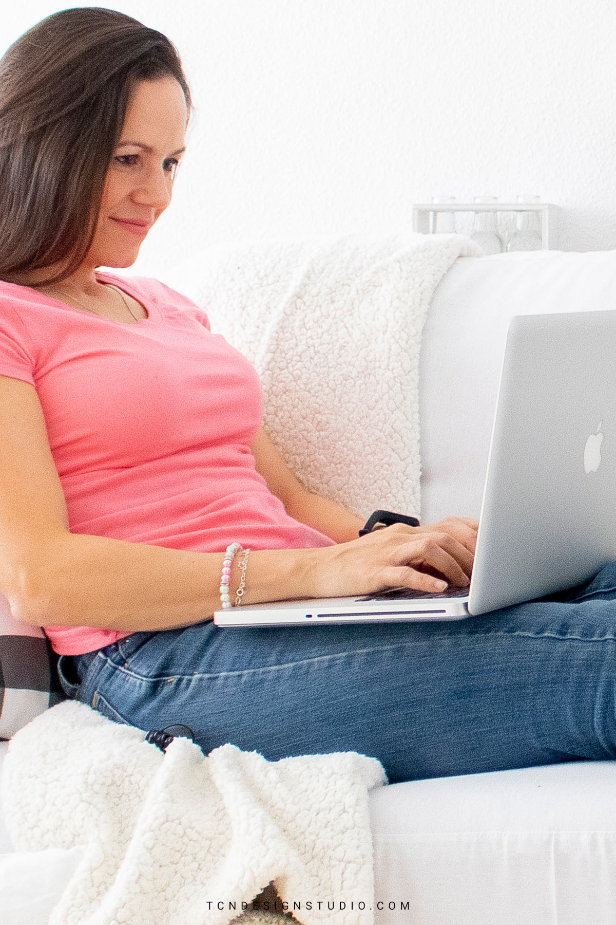 Woman using a laptop for digital work or browsing online.